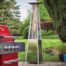 stainless steel tahiti patio heater with red bbq in foreground