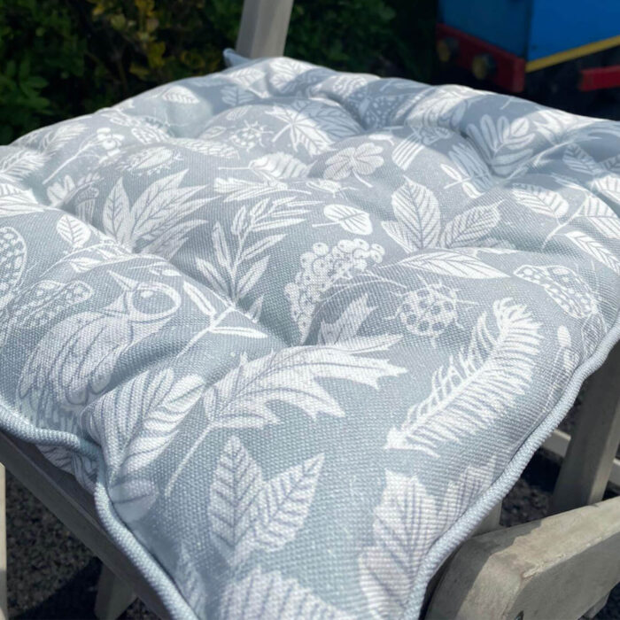 pale blue seat pad with white leaf pattern on polyester for wooden bistro set or garden furniture
