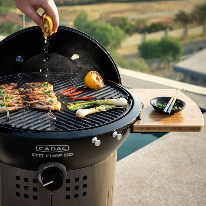image of cadac citi chef 50 grilling food poolside, for garden or outdoor urban living