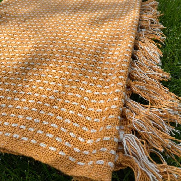 orange and white speckled throw with tassel ends perfect for your garden or picnic set up
