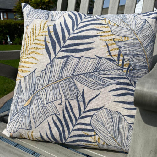 tropical jungle palm leave print in green on fabric cushion for home living sofa or garden furniture