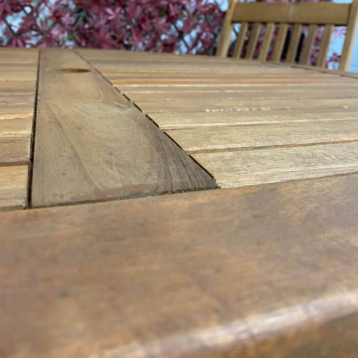 Detail of table of wooden 4 seat ballyholme dining seat that folds away for each storage and 4 folding chairs