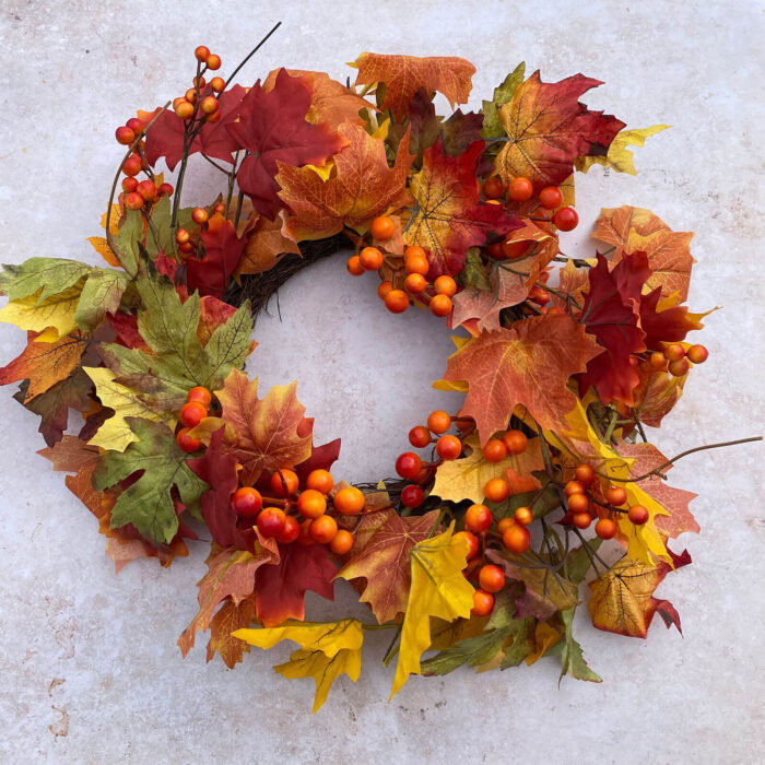 Full image of small woodland fall wreath with vibrant autumn colours and hand crafted floral designs for your front door or mantlepiece or as a table centrepiece