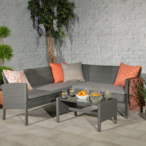 Browns bay corner coffee sofa set in grey rattan with small corner sofa and small coffee table with glass table top displayed in a patio area