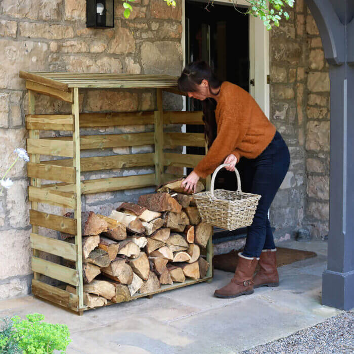 large standing wooden log store for the garden to store logs safely as a fireside accessory